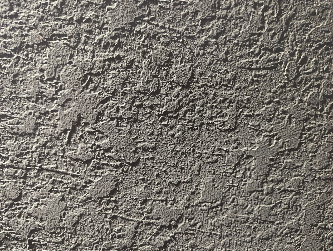 Strukturierte Putzoberfläche einer Hauswand in Nahaufnahme